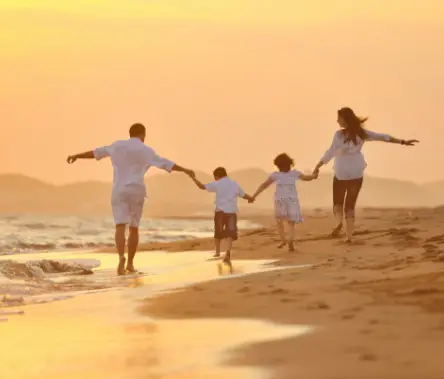 Happy family on beach sunset